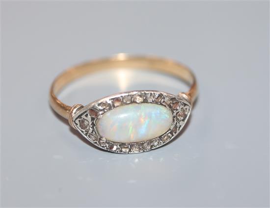 A 1920s yellow metal, white opal and rose cut diamond set ovoid dress ring, size O.